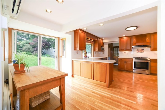 493 Salisbury St, Worcester, MA 01609 - kitchen with stainless steel appliances, recessed lighting, backsplash, light countertops, and light wood-style floors