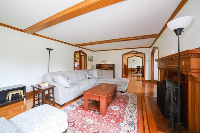 493 Salisbury St, Worcester, MA 01609 - living area with arched walkways, wood finished floors, ornamental molding, a fireplace, and beam ceiling