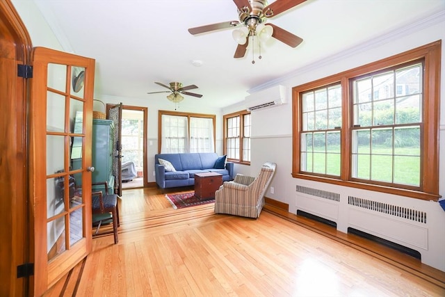 493 Salisbury St, Worcester, MA 01609 - living room with a wall mounted AC, light wood-style floors, ceiling fan, radiator, and ornamental molding