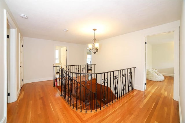 493 Salisbury St, Worcester, MA 01609 - hallway with an upstairs landing, wood finished floors, baseboards, and a chandelier
