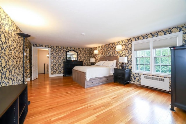 493 Salisbury St, Worcester, MA 01609 - bedroom featuring radiator heating unit, wallpapered walls, light wood finished floors, and baseboards