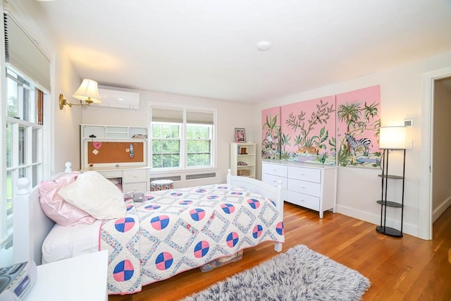 493 Salisbury St, Worcester, MA 01609 - bedroom featuring wood finished floors, a wall mounted AC, and baseboards