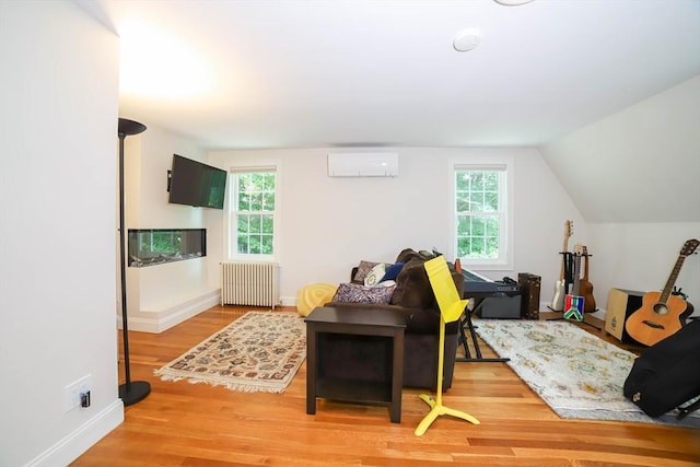 493 Salisbury St, Worcester, MA 01609 - living room featuring radiator, a wall mounted AC, wood finished floors, healthy amount of natural light, and vaulted ceiling