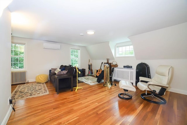493 Salisbury St, Worcester, MA 01609 - living area with radiator heating unit, light wood finished floors, a wall mounted air conditioner, healthy amount of natural light, and vaulted ceiling