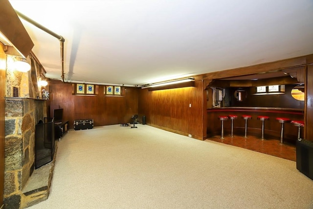 493 Salisbury St, Worcester, MA 01609 - below grade area featuring carpet flooring, wooden walls, a bar, and plenty of natural light