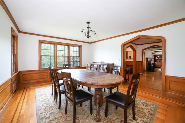493 Salisbury St, Worcester, MA 01609 - dining area with a chandelier, wainscoting, ornamental molding, light wood-type flooring, and arched walkways