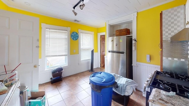 1-3 River Pl, Methuen, MA 01844 - kitchen with wainscoting, appliances with stainless steel finishes, light tile patterned floors, light countertops, and track lighting