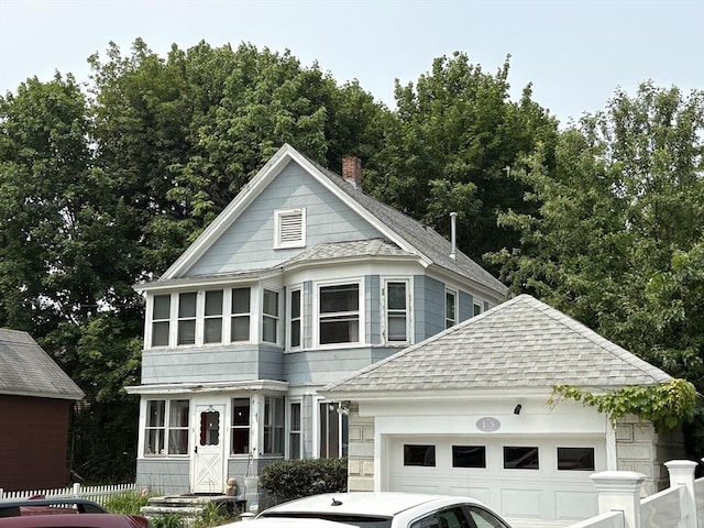 1-3 River Pl, Methuen, MA 01844 - view of front of home featuring a shingled roof, a garage, an outdoor structure, and a chimney