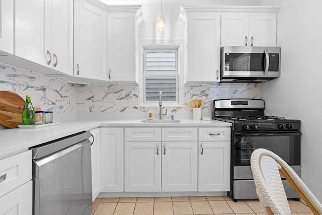 39 School St Unit 39, Brookline, MA 02446 - kitchen with stainless steel appliances, a sink, light countertops, and light tile patterned floors