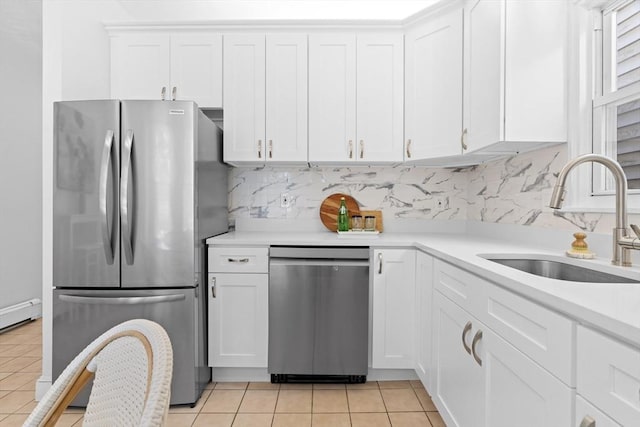 39 School St Unit 39, Brookline, MA 02446 - kitchen featuring appliances with stainless steel finishes, a sink, light tile patterned flooring, white cabinets, and light countertops