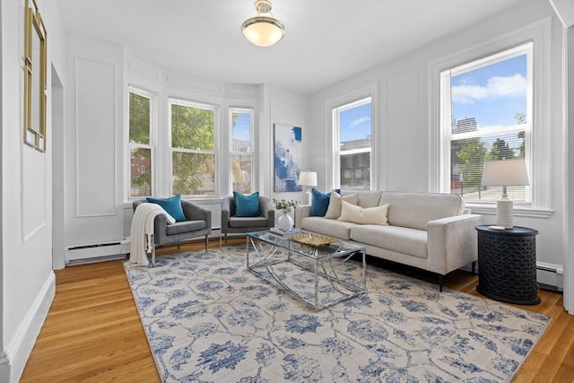39 School St Unit 39, Brookline, MA 02446 - living area featuring baseboard heating, healthy amount of natural light, light wood-style flooring, and a baseboard heating unit