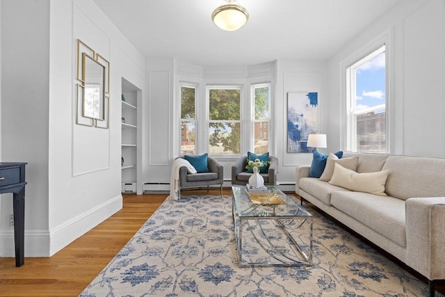 39 School St Unit 39, Brookline, MA 02446 - living room featuring wood finished floors, baseboards, and a baseboard heating unit