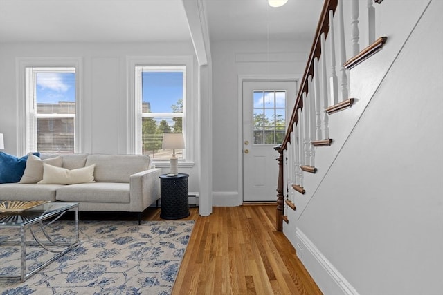 39 School St Unit 39, Brookline, MA 02446 - entryway with light wood finished floors, plenty of natural light, stairway, and a baseboard heating unit