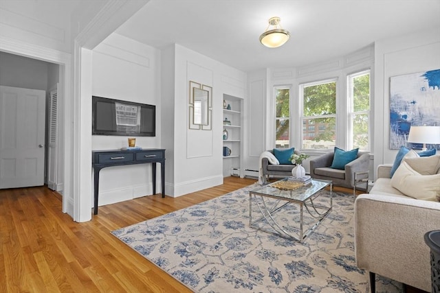 39 School St Unit 39, Brookline, MA 02446 - living area with built in features, wood finished floors, baseboard heating, and baseboards
