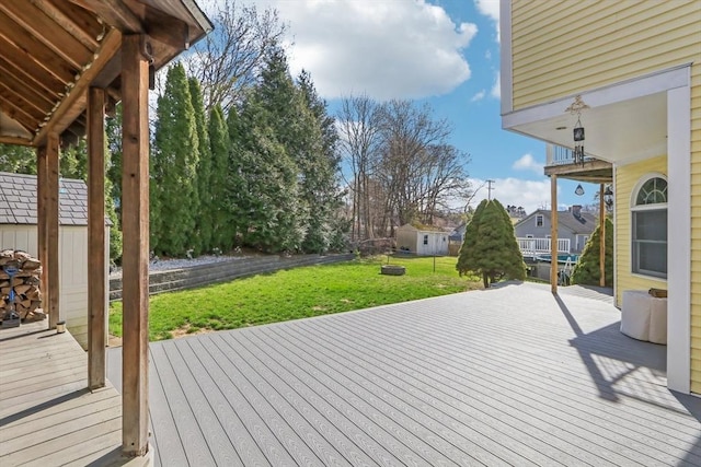 wooden terrace with a lawn, an outdoor structure, a residential view, and a storage shed