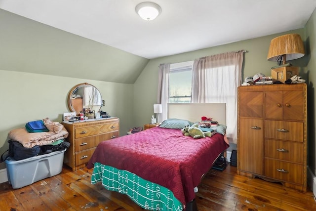 bedroom with lofted ceiling and hardwood / wood-style flooring