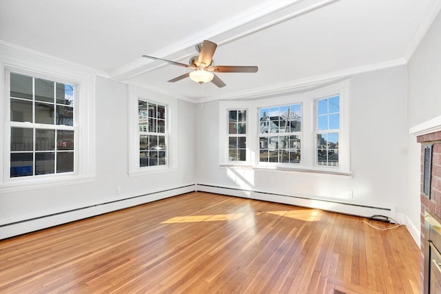 unfurnished room featuring a brick fireplace, light wood-type flooring, ceiling fan, and ornamental molding