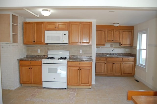 kitchen with tasteful backsplash, white appliances, a sink, and brown cabinets