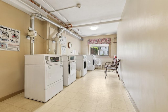 128 Pleasant St Unit 407, Arlington, MA 02476 - shared laundry featuring washing machine and dryer and baseboards