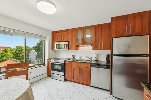128 Pleasant St Unit 407, Arlington, MA 02476 - kitchen with stainless steel appliances, baseboard heating, a sink, light marble finish floors, and glass insert cabinets