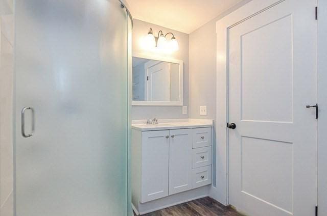 17 Harrison St, New Bedford, MA 02740 - bathroom featuring wood finished floors, a shower stall, and vanity
