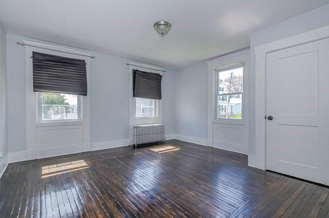 17 Harrison St, New Bedford, MA 02740 - foyer entrance with radiator heating unit, hardwood / wood-style floors, and baseboards