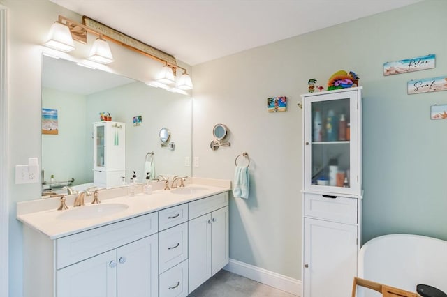 8 Dylans, Falmouth, MA 02536 - full bathroom with double vanity, a freestanding tub, and baseboards
