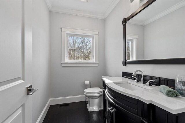 3 Toronto Ave, Gloucester, MA 01930 - half bathroom featuring baseboards, toilet, vanity, ornamental molding, and wood finished floors