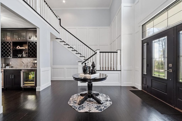 3 Toronto Ave, Gloucester, MA 01930 - foyer entrance with a decorative wall, wine cooler, bar with sink, dark wood finished floors, and stairway