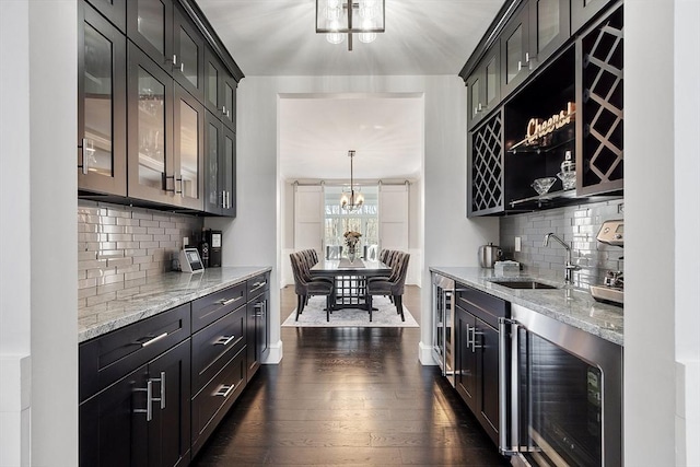 3 Toronto Ave, Gloucester, MA 01930 - bar area featuring a sink, a chandelier, dark wood-style floors, and backsplash