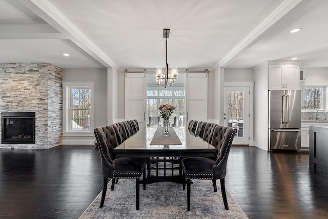 3 Toronto Ave, Gloucester, MA 01930 - dining space featuring plenty of natural light, a chandelier, dark wood-style floors, a fireplace, and recessed lighting