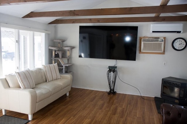 living room with wood-type flooring, a wall unit AC, and beamed ceiling