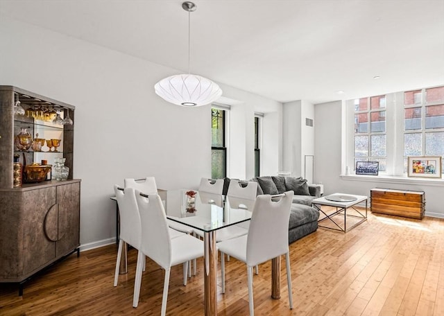 dining room with hardwood / wood-style flooring and baseboards