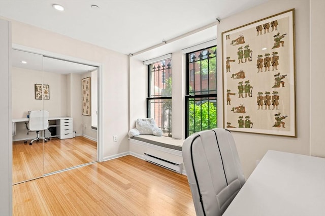 office area with a baseboard radiator, wood finished floors, baseboards, and recessed lighting