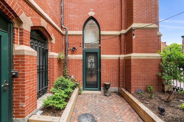 property entrance with brick siding