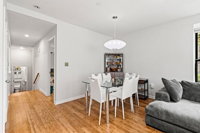 dining area featuring light wood-style floors, baseboards, and recessed lighting