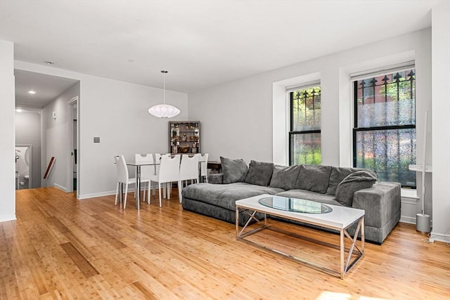 living room with light wood-style flooring and baseboards