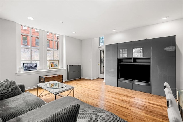 living area featuring wood finished floors, recessed lighting, and baseboards