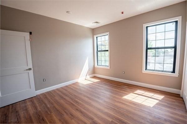 unfurnished room featuring hardwood / wood-style flooring