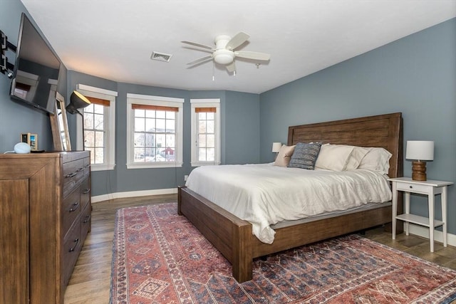 bedroom with dark wood-type flooring and ceiling fan