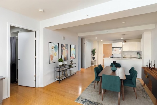 dining area featuring light wood-style floors, recessed lighting, and baseboards