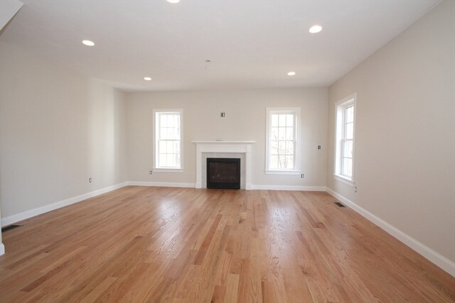 unfurnished living room featuring light wood-type flooring