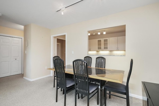 131 Coolidge Ave Unit 422, Watertown, MA 02472 - dining room with light colored carpet, rail lighting, and baseboards