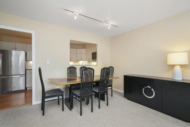 131 Coolidge Ave Unit 422, Watertown, MA 02472 - dining area with baseboards, rail lighting, and light colored carpet