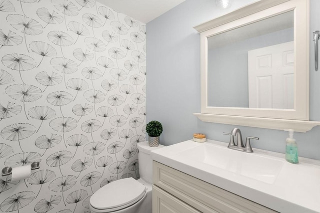 bathroom with vanity, curtained shower, and toilet