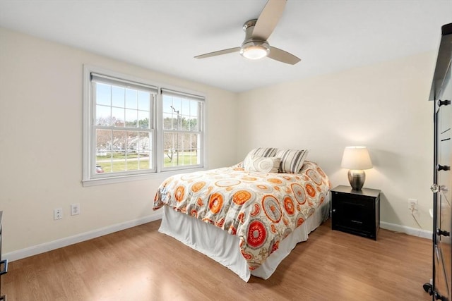 bedroom with baseboards, a ceiling fan, and wood finished floors