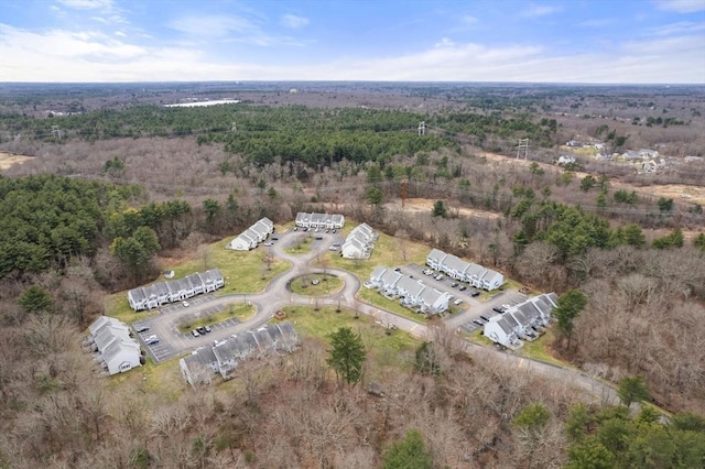 bird's eye view with a wooded view