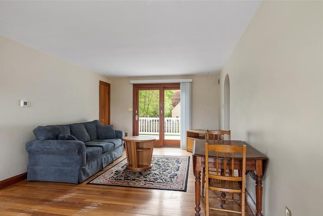 16 Elm St, Leominster, MA 01453 - living room featuring light wood-style flooring, arched walkways, and baseboards