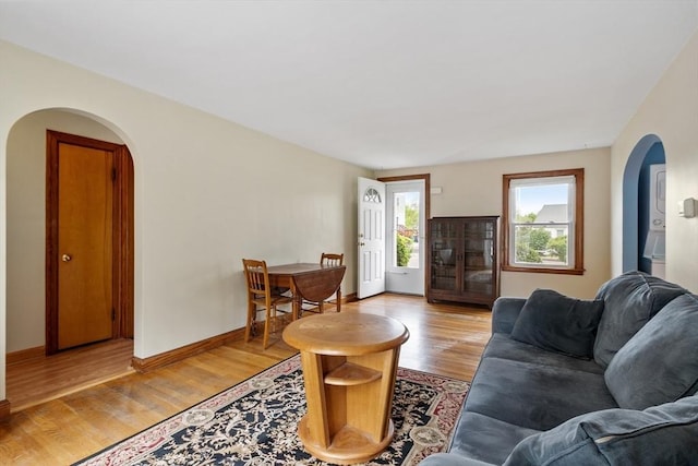 16 Elm St, Leominster, MA 01453 - living room with arched walkways, light wood-style floors, and baseboards