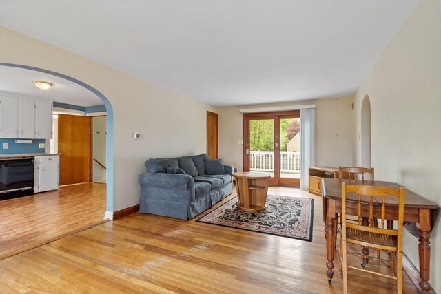 16 Elm St, Leominster, MA 01453 - living room featuring arched walkways, light wood-type flooring, and baseboards